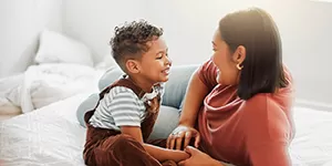 Woman traveling with backpack and looking over beach scene.